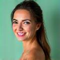 Sarah M., 42, smiling contentedly after completing a nutrition challenge.